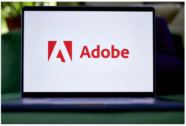 Логотип Adobe на ноутбуке.
                Фотограф: Гэбби Джонс~Bloomberg